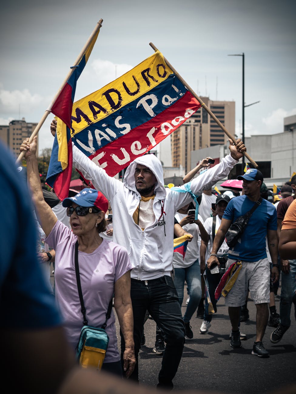 a man holding a flag and holding a sign