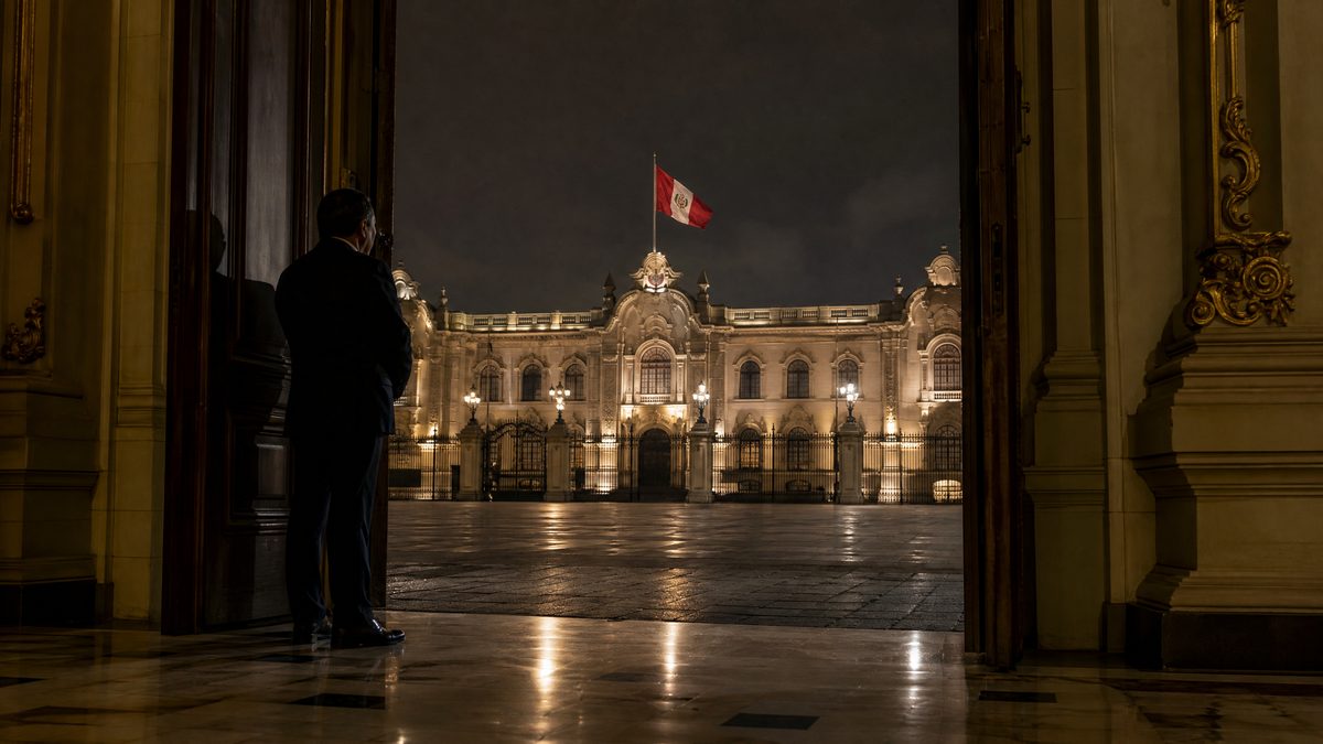 Palacio de gobierno de Lima de noche con bandera peruana